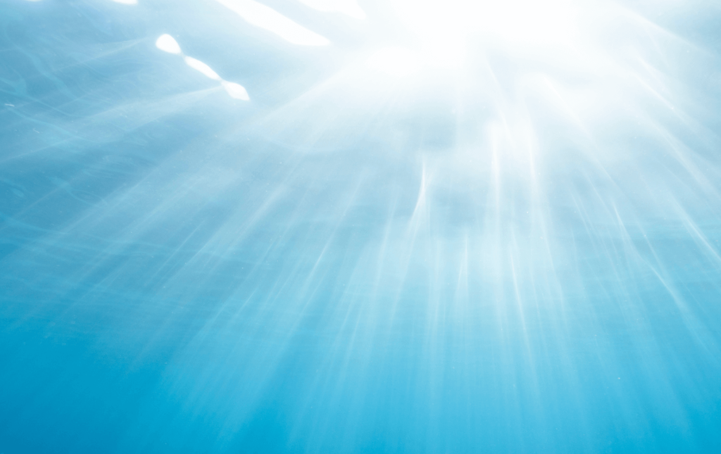 Sunlight rays shining through blue water