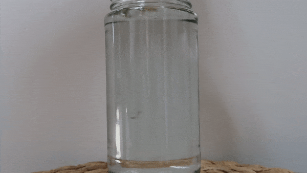 Aǹalemma Structured Water Wand stirring a jar of water