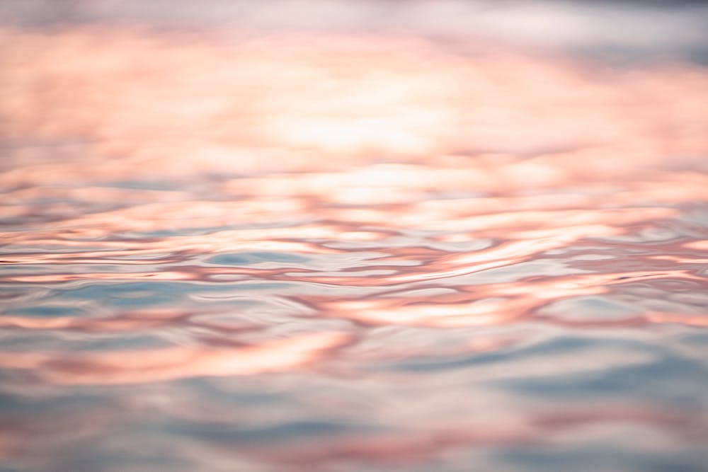 Water with a pink and orange shimmer