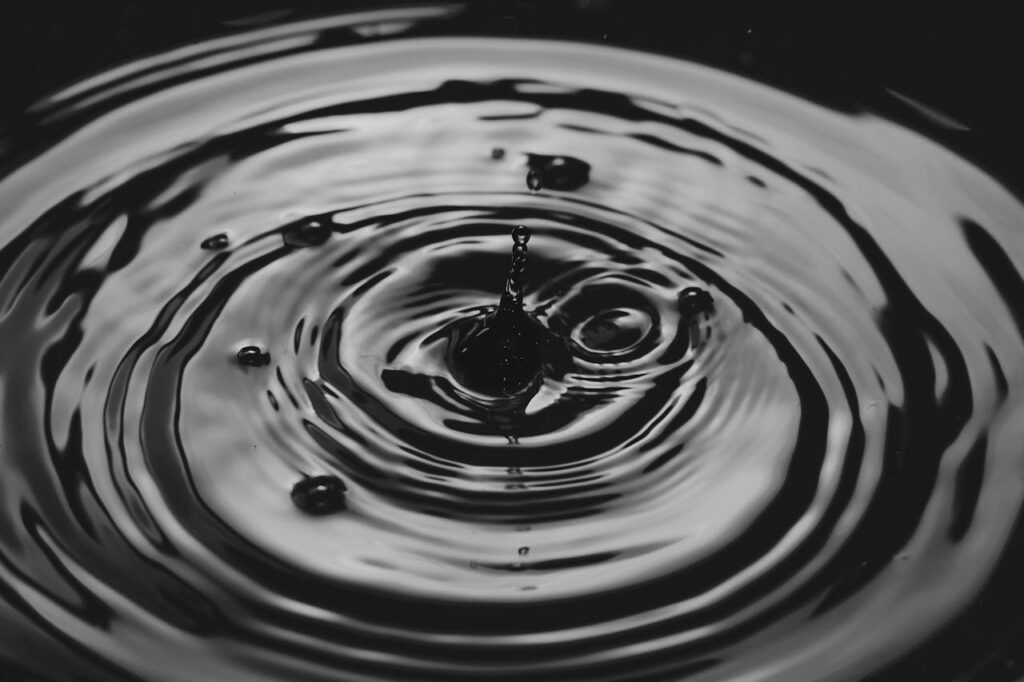 A water droplet causing a splash in a large pool of water